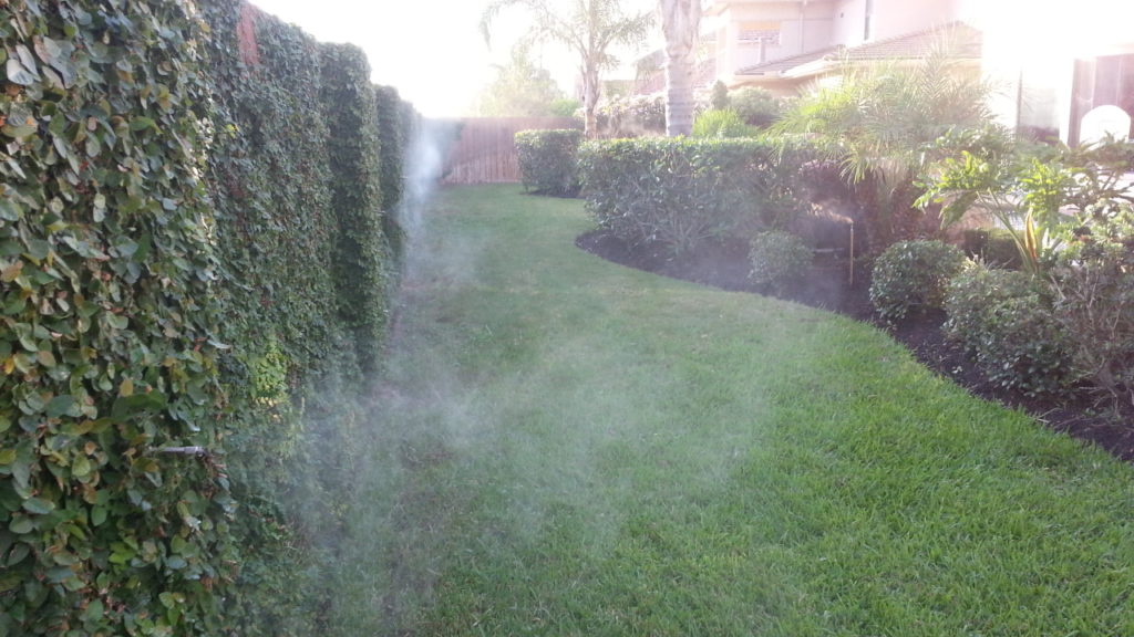 backyard with mosquito misting system spraying